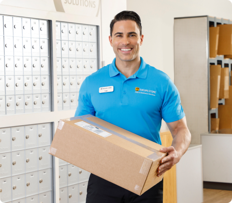 Man holding a package at a The UPS Store.